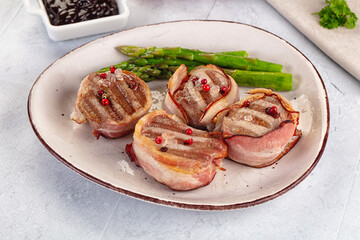 Tasty grilled pork medallion with bacon