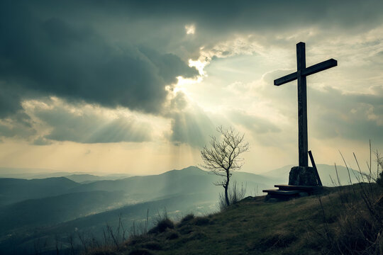 Wooden cross on a hillside under dramatic cloudy sky with rays of light shining through, capturing a serene and spiritual atmosphere in nature - Powered by Adobe