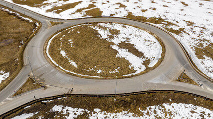 Aerial view of a roundabout in a snowy valley.