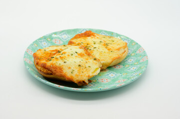 Two pieces of bread with cheese on top of a blue plate