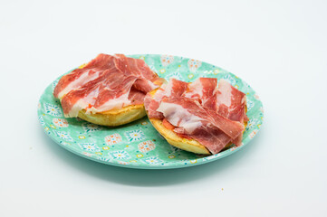 Two ham sandwiches on a plate