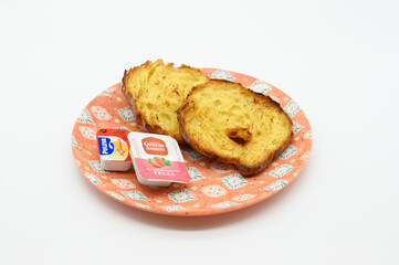 A plate with two pieces of toast and a condiment