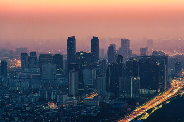 Obraz premium Crowded financial skyscraper building with rush traffic in the morning at Bangkok city