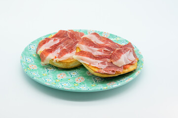Two ham sandwiches on a plate
