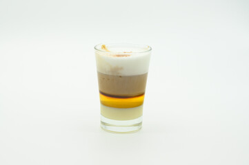 A glass of coffee with cream and sugar