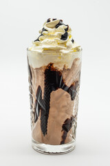 A glass of chocolate milk with whipped cream on top