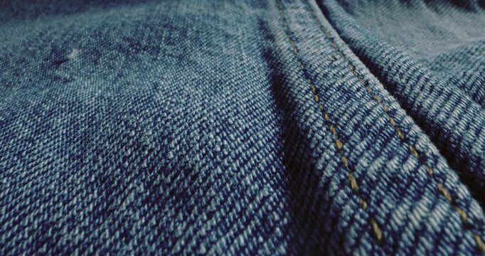 Macro Slider of Blue Denim Fabric with Detailed Stitching &ndash; Textured Jeans Material, Classic Weave Pattern, and Fashion Textile