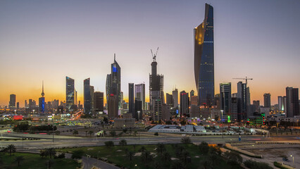 Skyline with Skyscrapers day to night timelapse in Kuwait City downtown illuminated at dusk. Kuwait City, Middle East