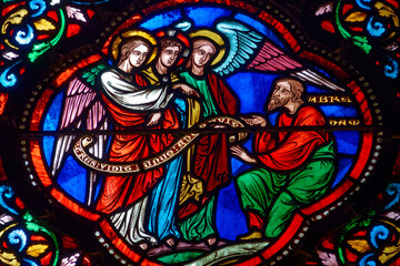Stained (19th century) glass of Abraham receives a visit from three angels.