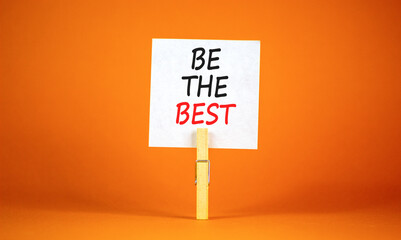 Motivational be the best symbol. Concept words Be the best on beautiful white paper on clothespin. Beautiful orange background. Business motivational be the best concept. Copy space.