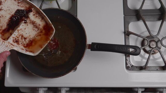 Pouring Greese Into Pan