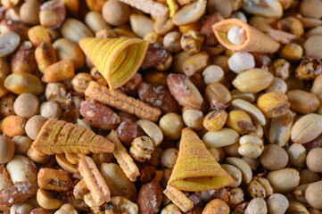 Colorful assortment of crunchy snacks scattered across a textured surface