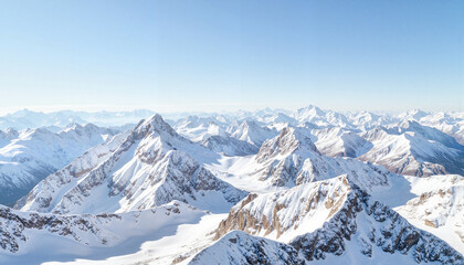 Majestic snow-capped mountain peaks under clear midday sky, tranquility
