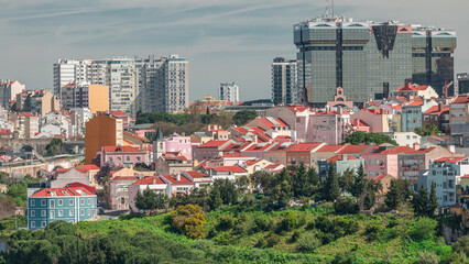 Aerial view of Lisbon skyline with Amoreiras shopping center towers. Historic buildings near Campo...