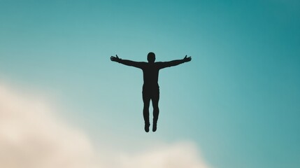 Silhouette of a person soaring against a blue sky with outstretched arms conveying freedom and exhilaration