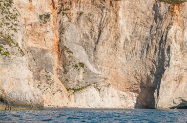 Turquoise waters embrace white cliffs as the sun sets over Zakynthos. Explore the breathtaking beauty of this Greek island, revealing its tranquil spots like Shipwreck Beach