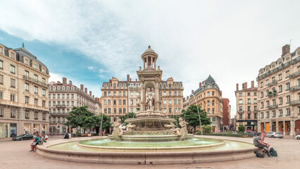 Fototapeta premium Hyperlapse of Place des Jacobins in Lyon, France, featuring the ornate Fontaine des Jacobins surrounded by historic buildings.