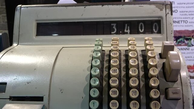 Antique metal cash register with tall numbered keys