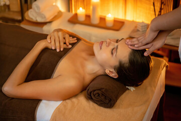 Caucasian woman enjoying relaxing anti-stress head massage and pampering facial beauty skin...