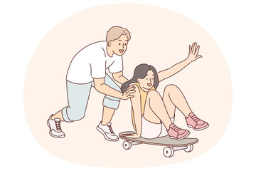 Young couple fun in skate park, enjoying pleasure of relaxing together and riding skateboard