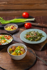A set table, tzimmes, chelnt, shakshuka and couscous with dried fruits