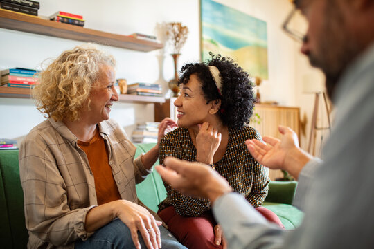 Lesbian couple in therapy session with counselor at home - Powered by Adobe