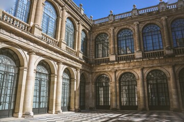 Elegant architectural courtyard with arched windows.