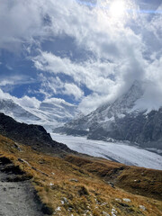 mountain landscape in the mountains with clouds over glacier in the fall