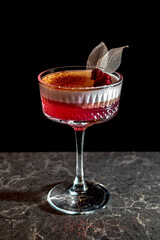 Red alcohol  cocktail with raspberry and leaves