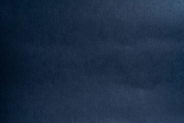 Smooth, dark textured cardboard paper background for design projects, invitations or creative displays.