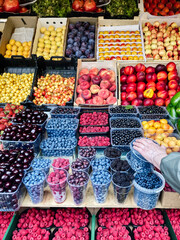 fresh summer berries and fruits at the farmers market, fruit stand
