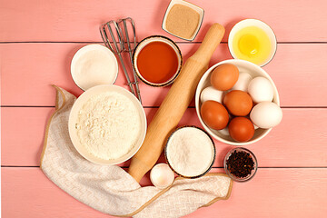 Recipe with eggs, flour, sugar, honey, cinnamon, yeast and butter. Kitchen background of cooking. Culinary ingredients for making pie and bread, Modern bakery concept