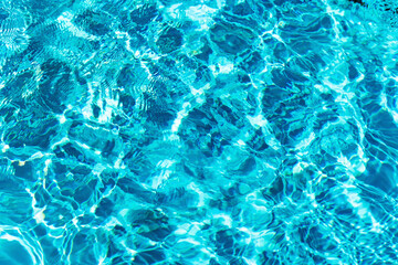 Ripples on the surface of the water in a blue swimming pool