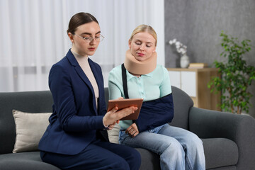 Injured woman having meeting with lawyer in office