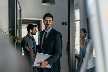 Group of businesspeople in formal attire discussing financial reports