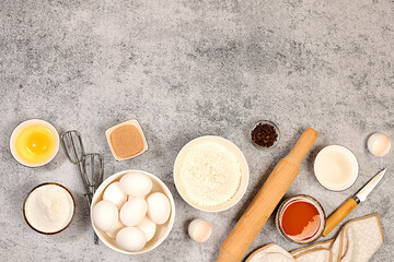 Cooking ingredients for making pie and bread, recipe with eggs, flour, sugar, honey, cinnamon, yeast and butter. Kitchen background of food preparation with space for text. Concept of modern bakery,