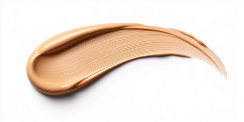 Obraz premium A brush stroke of a foundation is shown on a white background. The brush stroke is long and curved, and it is a creamy color. Concept of elegance and sophistication