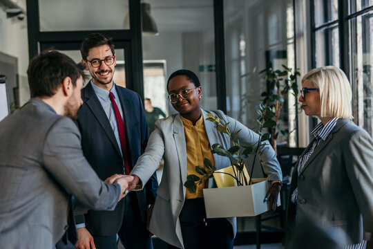 A group of coworkers is saying goodbye to an old colleague who is leaving the office. Concept of loosing job