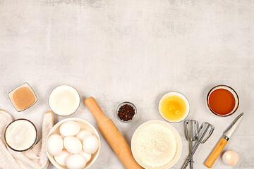 Cooking ingredients for making pie and bread, recipe with eggs, flour, sugar, honey, cinnamon, yeast and butter. Kitchen background of food preparation with space for text. Concept of modern bakery