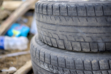 Two used tires stacked on the ground