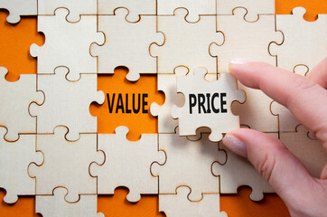 Price and Value symbol. Concept word Price and Value on wooden puzzle. Businessman hand. Beautiful...