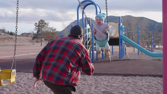 Father Playing with Daughter on the Swingset Slowmotion