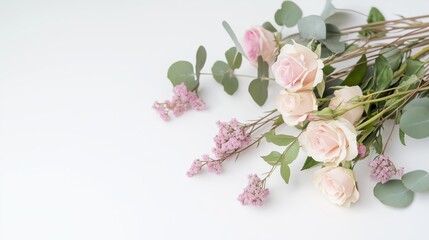 Naklejka premium Flat lay of fresh blooming roses and greenery, ideal for spring and nature-inspired designs.