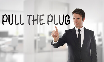 Businessman touch a transparent screen with "Pull the plug" quote