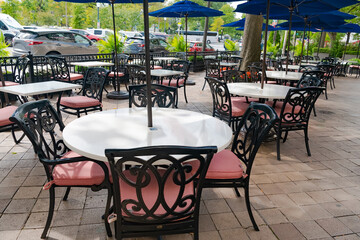 empty street cafe in big american town on summer day. Tables, chairs and umbrellas.