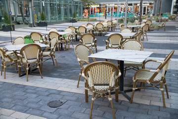 empty street cafe in washington dc on summer day. tables, chairs and umbrellas.