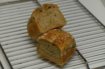 Freshly baked artisan bread cooling on a rack in a cozy kitchen setting