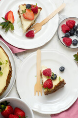 Pieces of cheesecake with berries on plates.top veiw..style hugge