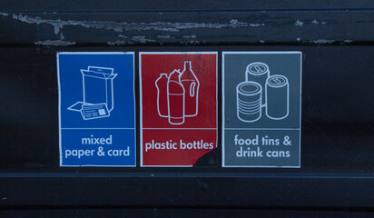 Schematic representations of different types of waste. Mixed paper and card with blue color, plastic bottles with red color, food tins and drink cans with grey color.