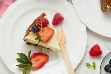 Pieces of cheesecake with berries on plates.top veiw..style hugge